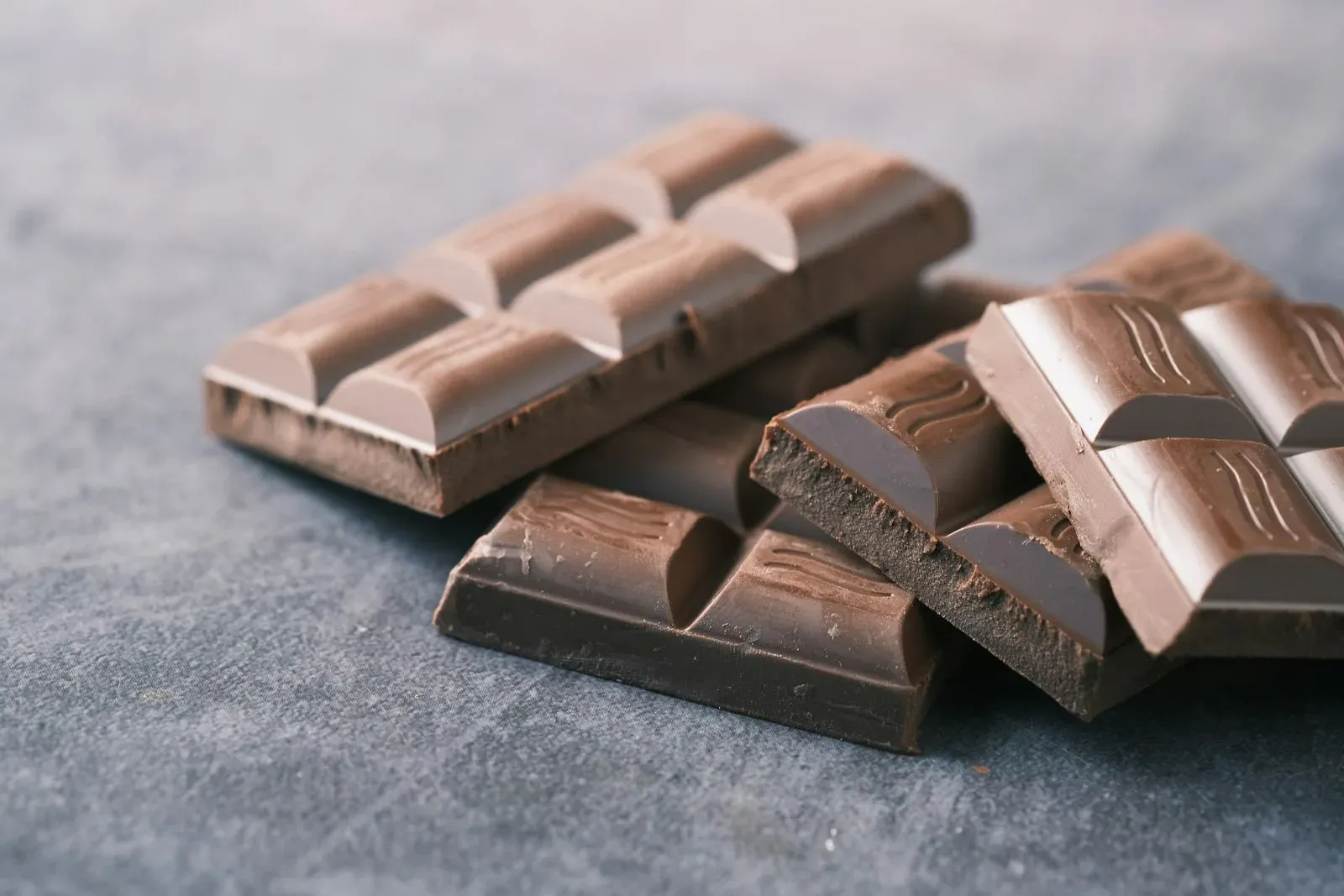 Bars of milk and dark chocolate on a table.