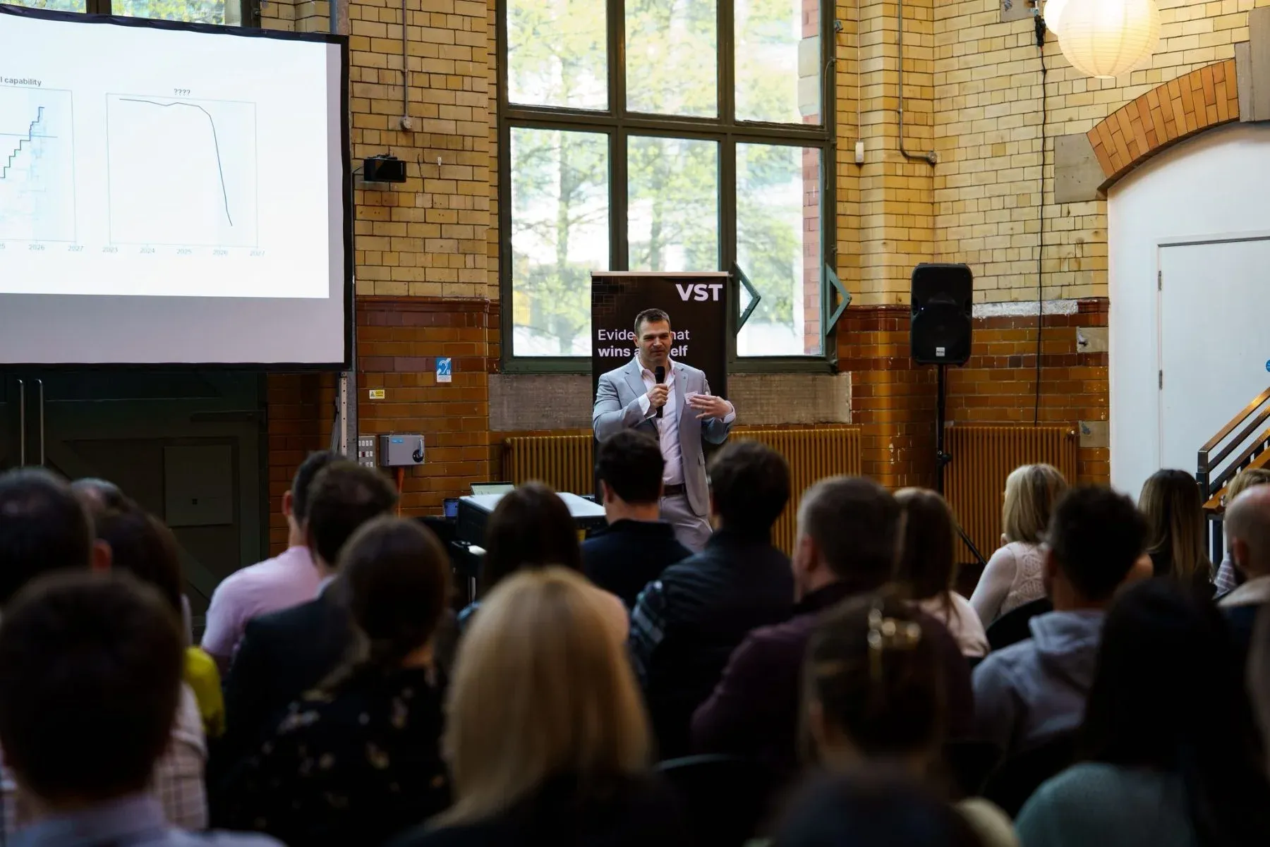 A speaker presenting to the room at a previous Vazen event